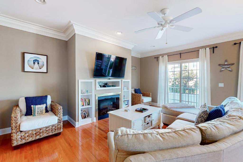 a living room with two couches and a tv at Loggerhead - Leatherback #903 in Bethany Beach