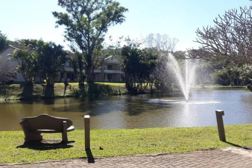 a fountain in front of a body of water at Eden Wilds 87 in Port Edward