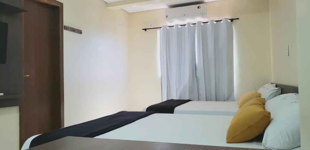 Postel nebo postele na pokoji v ubytování Infinity Hotel