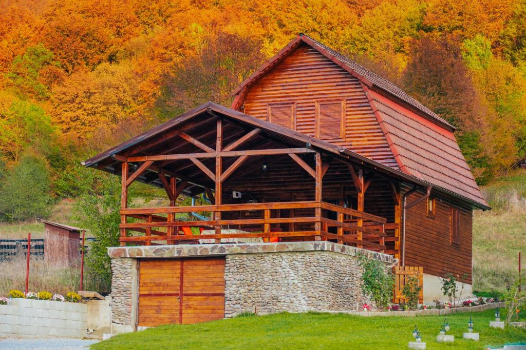 a large wooden building with a large roof at Cabana Mihai in Sovata