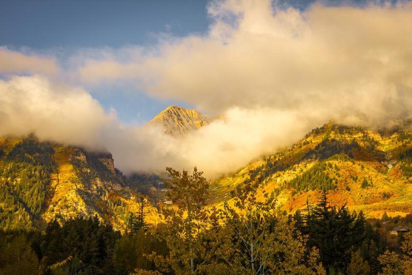 a mountain with clouds on top of it at Treehouse On The Stream Sundance, Utah in Sundance