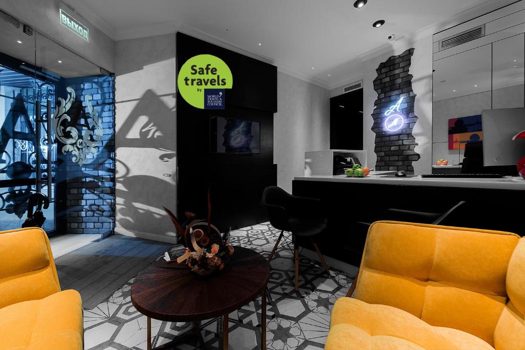 a lobby with two chairs and a sign that reads safe travels at Hotel Arkadia Nova in Saint Petersburg