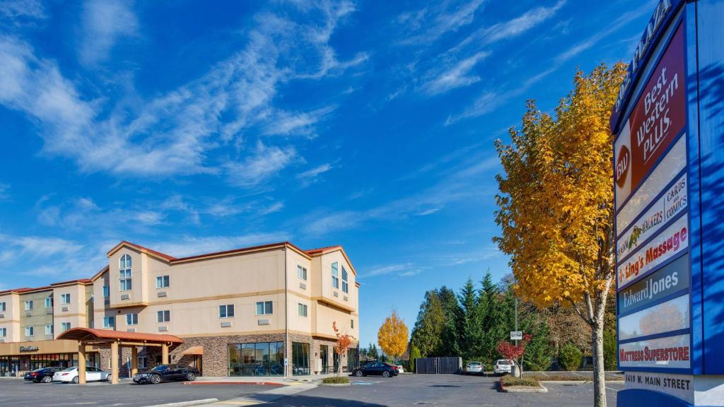 a building with a sign in a parking lot at Best Western Plus Battleground Inn & Suites in Battle Ground