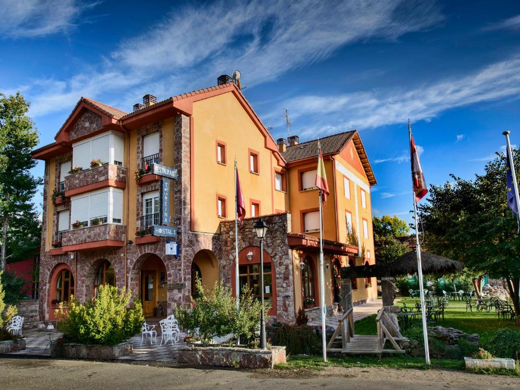 a building with flags in front of it at Tierra de la Reina in Boca de Huérgano