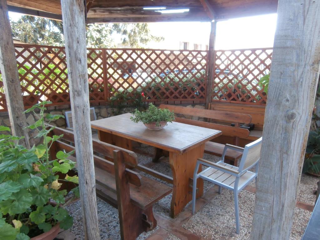 a wooden table and chairs on a patio at Busalacchi B&B in Mondello