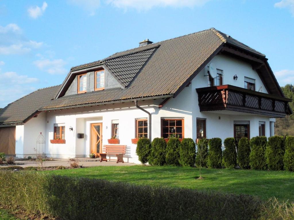 a white house with a black roof at Holiday flat in the Sauerland with terrace in Medebach