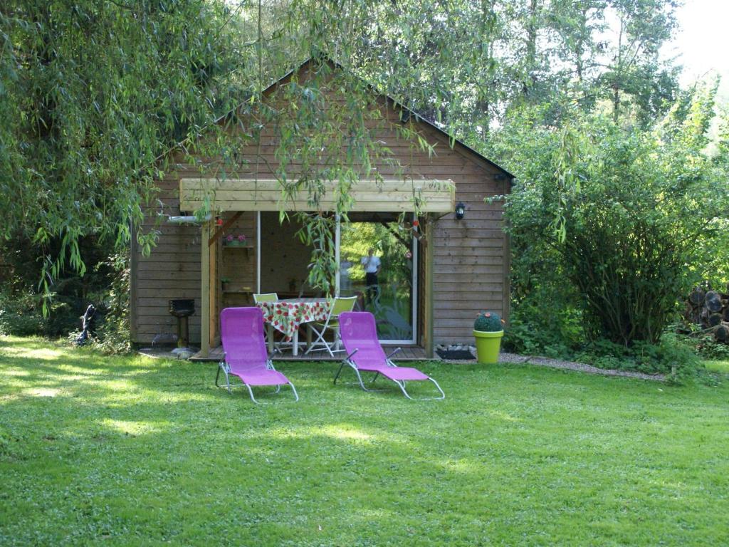 a table and chairs in front of a shed at Lovely Holiday Home in Le Ponchel with Garden Pond in Le Ponchel