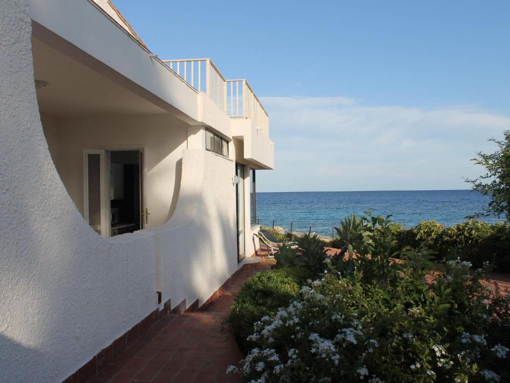 a white building with a view of the ocean at Belvilla by OYO Villa Eirene in Fontane Bianche