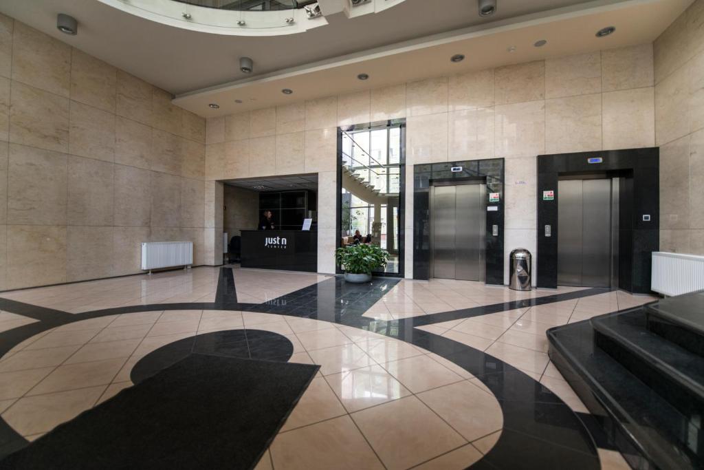 an empty lobby with two elevators in a building at Just Apartments in Wrocław