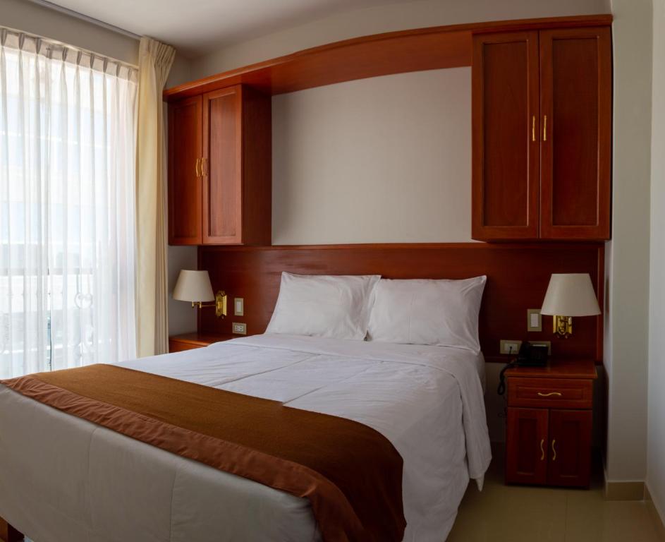 A bed or beds in a room at Retama Hotel