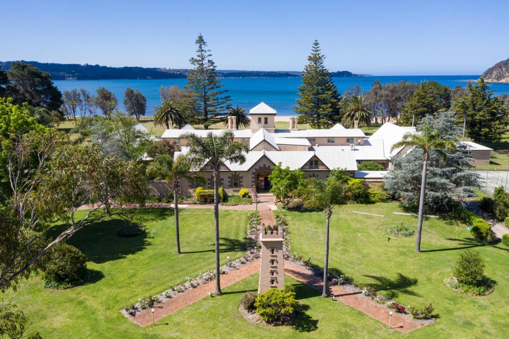 an aerial view of a large house with a clock tower at Seahorse Inn Hotel & Villas in Eden