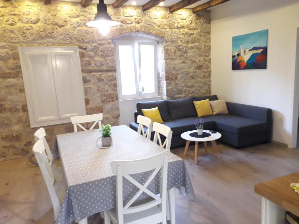 a living room with a couch and a table at Apartments Bepi in Komiža