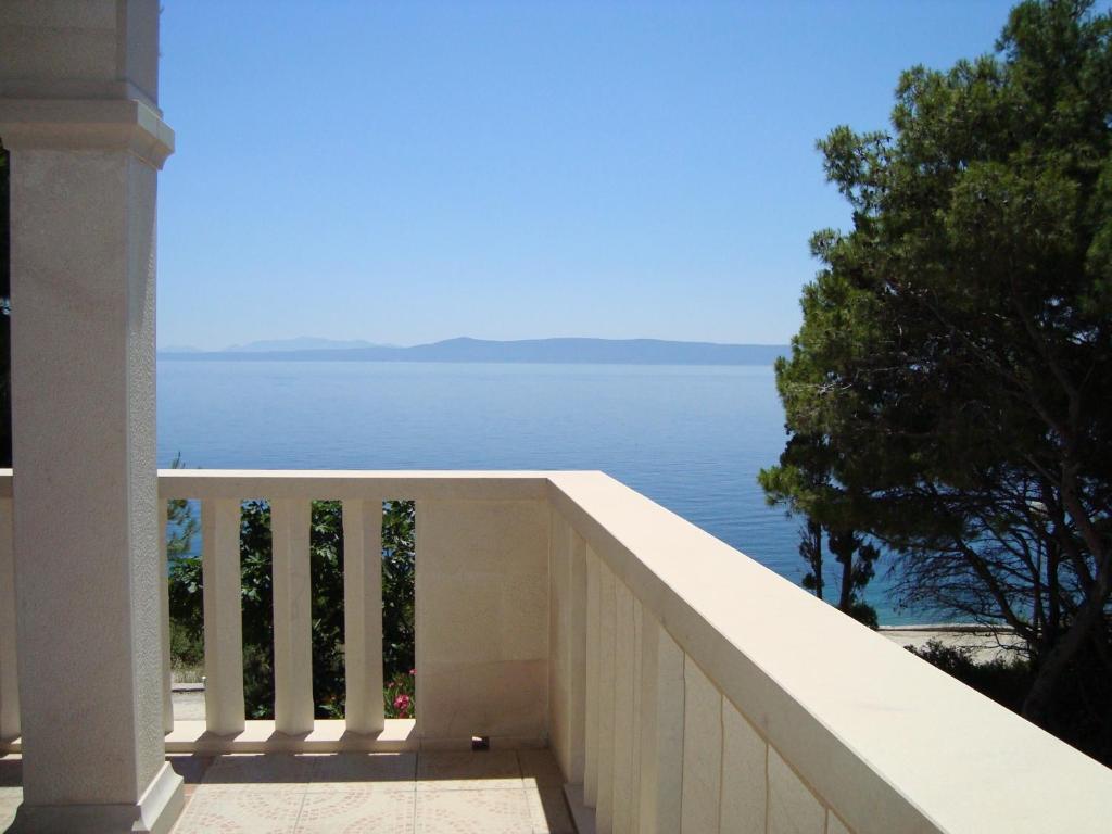 a balcony of a house with a view of the water at Villa Adagio Apartments in Sumartin