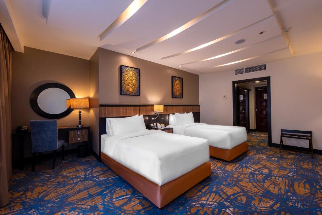 Postel nebo postele na pokoji v ubytování Al Ghufran Safwah Hotel Makkah