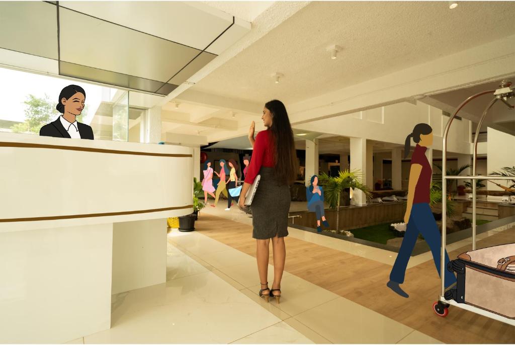 a woman standing in a lobby with a mannequin at Niasha Youth Hostel in Ullāl