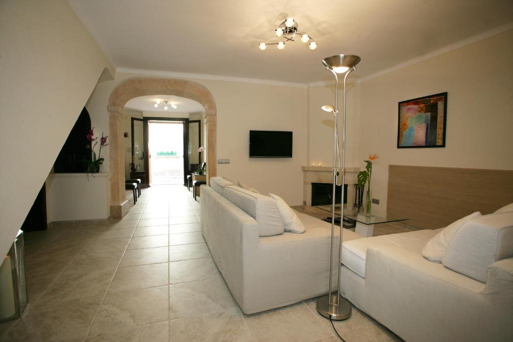 a living room with two white couches and a television at Sa Posada in Porreres