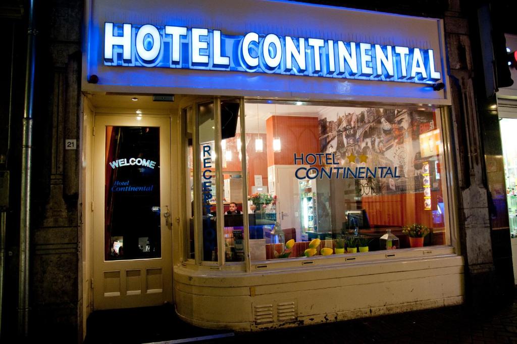 a store with a neon sign on the front of it at Hotel Continental Amsterdam in Amsterdam