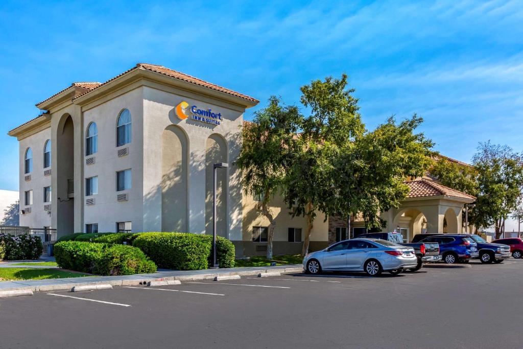 um hotel com carros estacionados em frente a um parque de estacionamento em Comfort Inn & Suites Phoenix North - Deer Valley em Phoenix