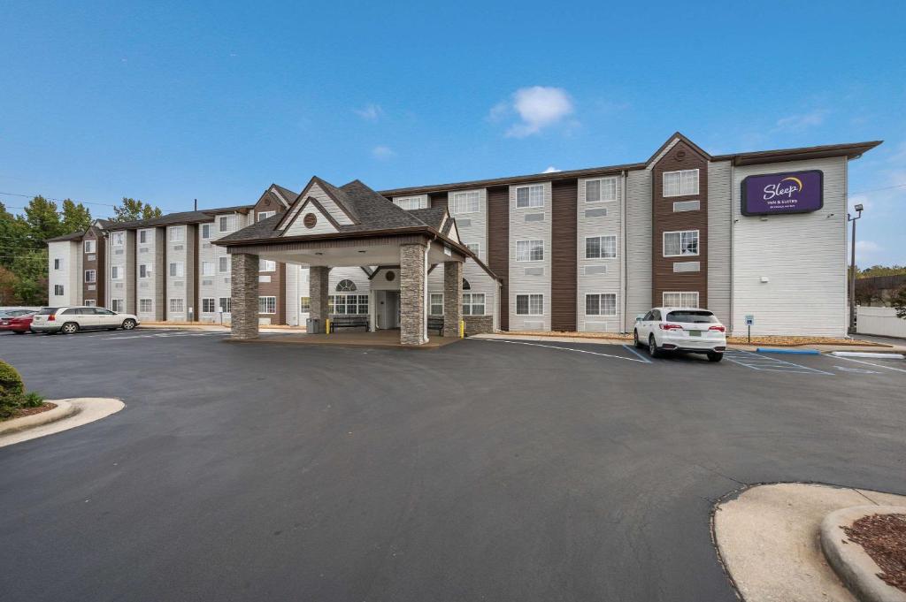 a large building with a parking lot in front of it at Sleep Inn & Suites in Decatur