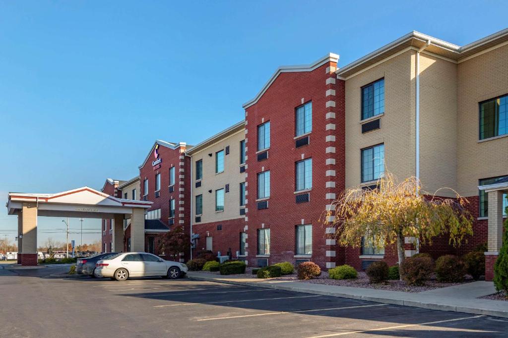 a car parked in a parking lot in front of buildings at Comfort Suites Grand Rapids South in Grand Rapids