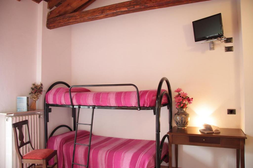 Postel nebo postele na pokoji v ubytování Hotel La Locanda