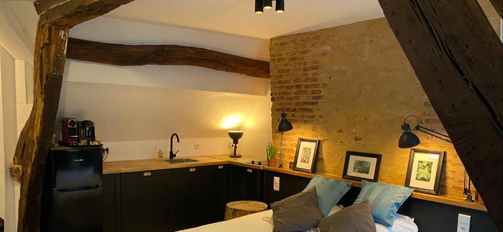 a kitchen with a black refrigerator and a counter at Hôtel De La Cathédrale in Rouen