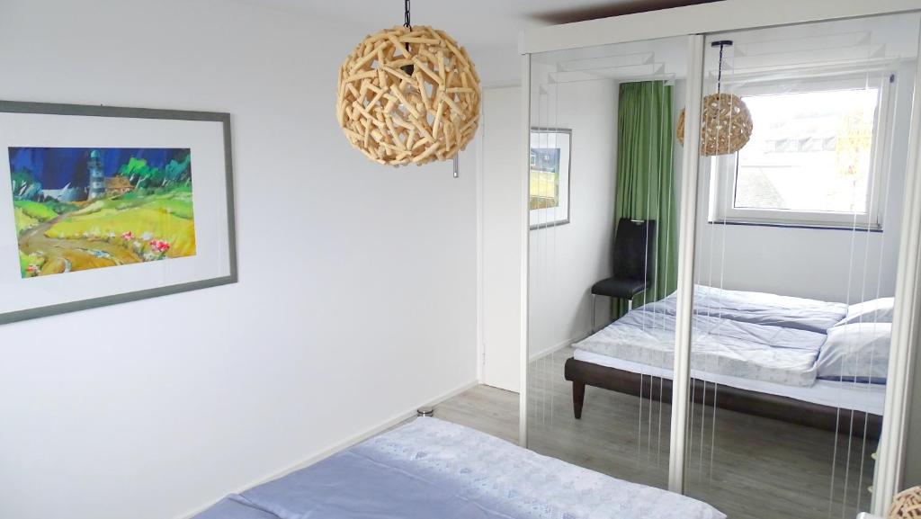 a bedroom with a bed and a mirror at Nordsee Residenz Appartement 60 in Westerland (Sylt)