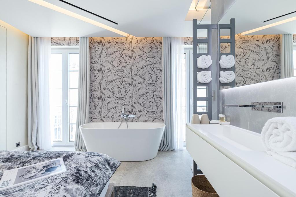 Postel nebo postele na pokoji v ubytování Le Dortoir Boutique Suites