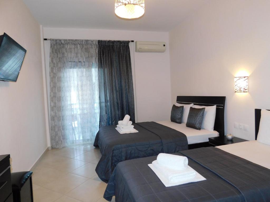 a hotel room with two beds and a window at Anna house 4 in Sarti