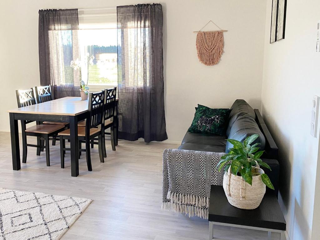 a living room with a couch and a table at Cozy apartment with sauna in Haapavesi