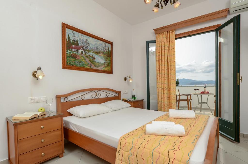 a bedroom with a bed and a view of the ocean at Dolphin Studios in Agia Anna Naxos