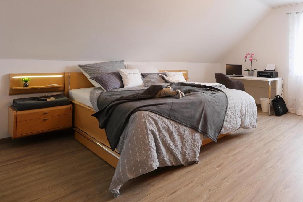 a bedroom with a bed with a dog laying on it at Ferienhaus Däschinger in Mastershausen