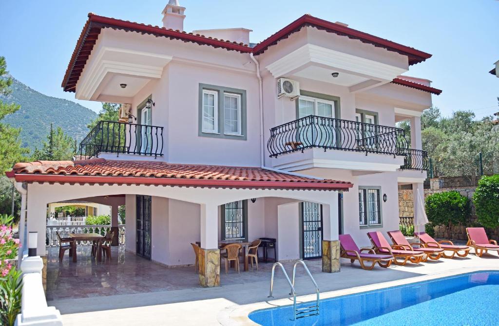 a villa with a swimming pool and a house at Villa Ahad in Fethiye