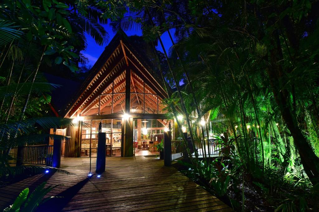 a wooden walkway leading to a resort at night at Ferntree Rainforest Lodge in Cape Tribulation