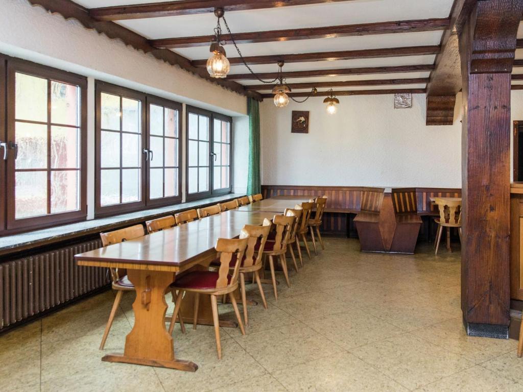 a dining room with a long table and chairs at Large group house beautifully located in Eifel in Ammeldingen