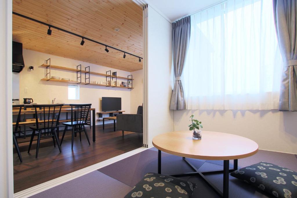 a living room with a table and a dining room at Fujiyasan in Fujikawaguchiko