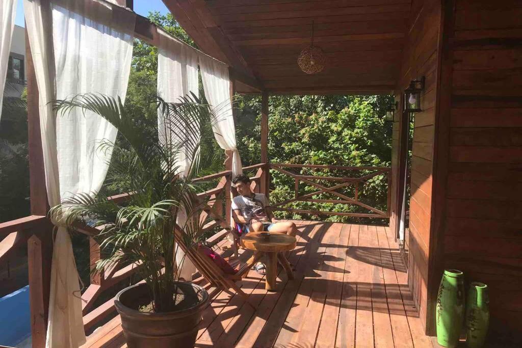 a boy sitting on the porch of a house at blue angel 3 in Playa del Carmen