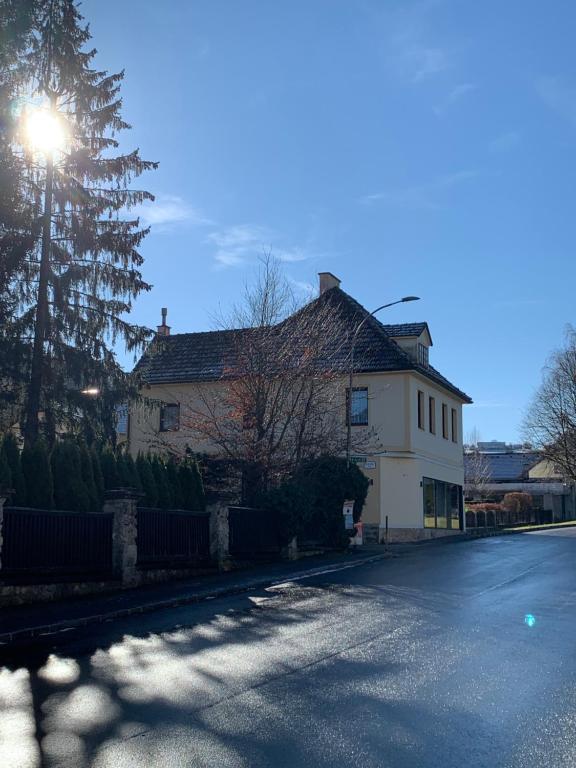 a house with the sun shining on a street at HAUS ZWEI in Aspang Markt