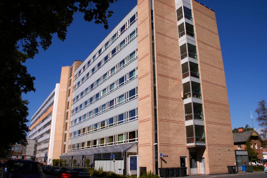 a tall brick building with windows on a street at Ullev&aring;l Hotel in Oslo
