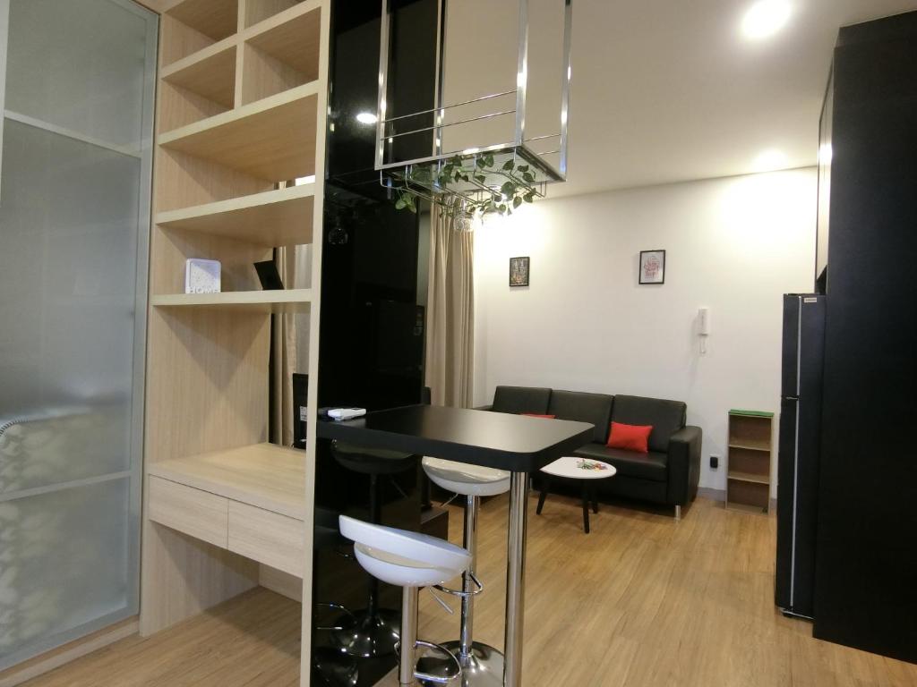 a kitchen and living room with a black table and chairs at Landmark Residence 1 SOHO 2pax by A's Homestay 8 in Kajang