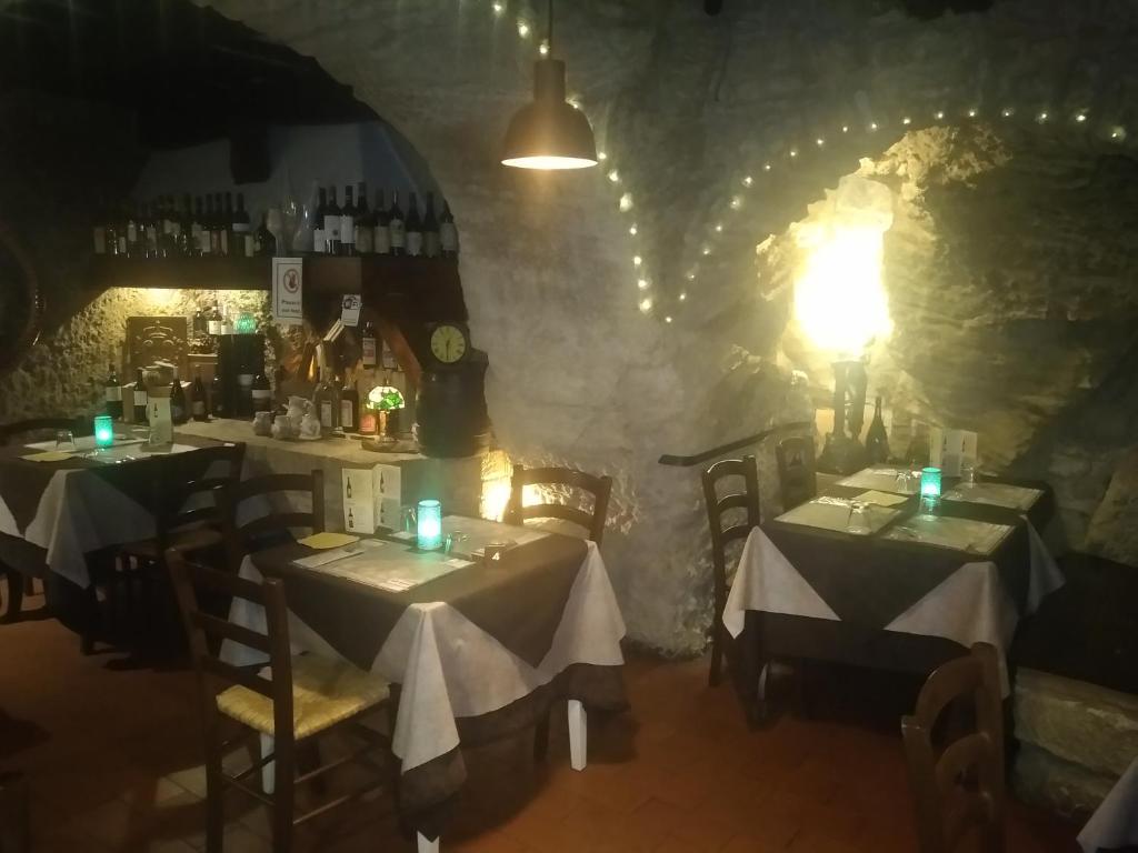 a dining room with two tables in a cave at Locanda Cantina Di Bacco in San Marino