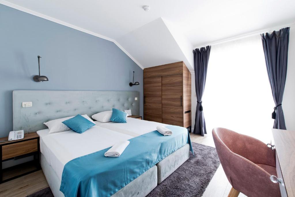 Postel nebo postele na pokoji v ubytování Hotel Perla