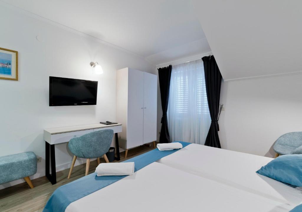 Postel nebo postele na pokoji v ubytování Hotel Perla