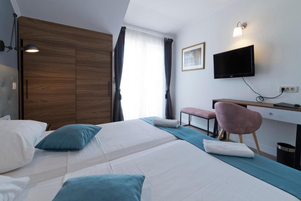 Postel nebo postele na pokoji v ubytování Hotel Perla