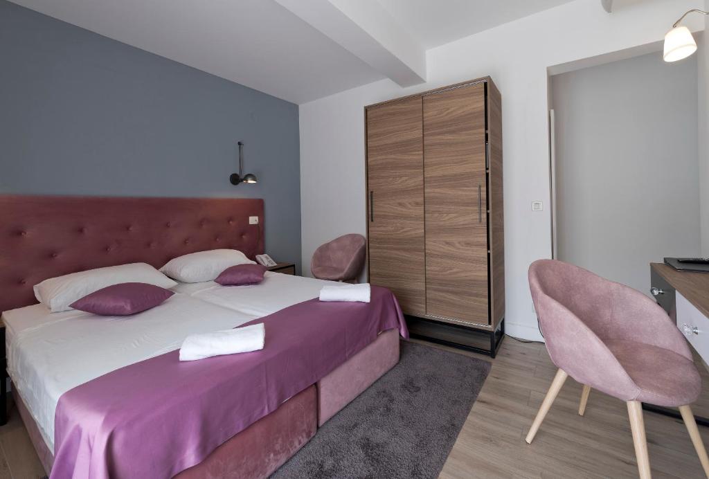 Postel nebo postele na pokoji v ubytování Hotel Perla