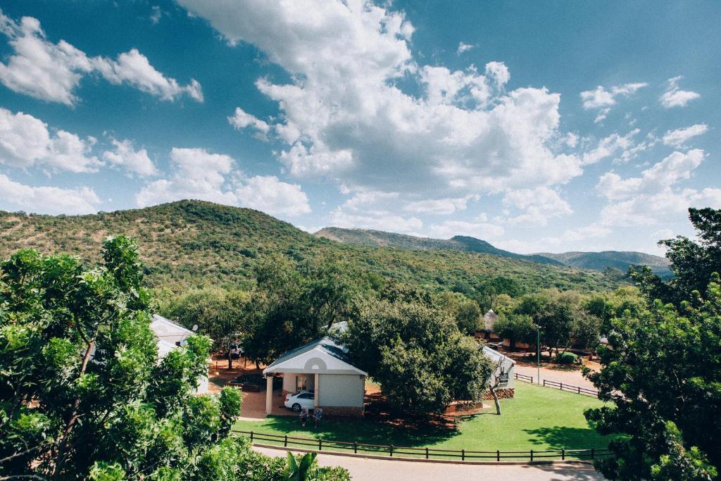 a gazebo in a park with mountains in the background at ATKV Buffelspoort in Rustenburg