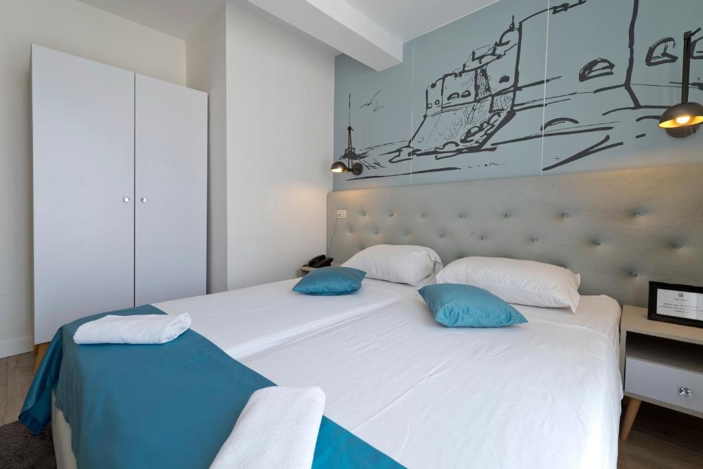 Postel nebo postele na pokoji v ubytování Hotel Perla