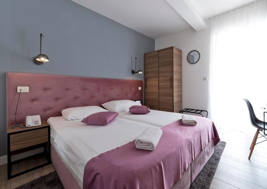 Postel nebo postele na pokoji v ubytování Hotel Perla