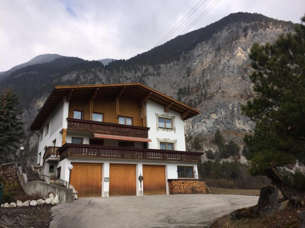 a large house with a mountain in the background at Haus Eiter in Nassereith