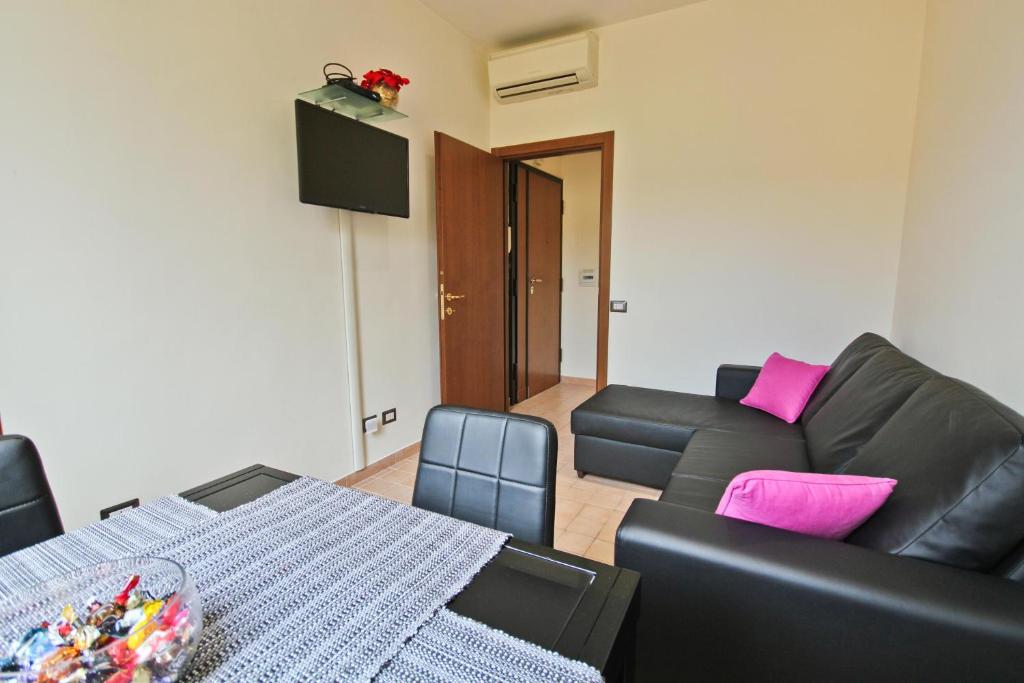 a living room with a couch and a table at San Pietro's Home in Rome